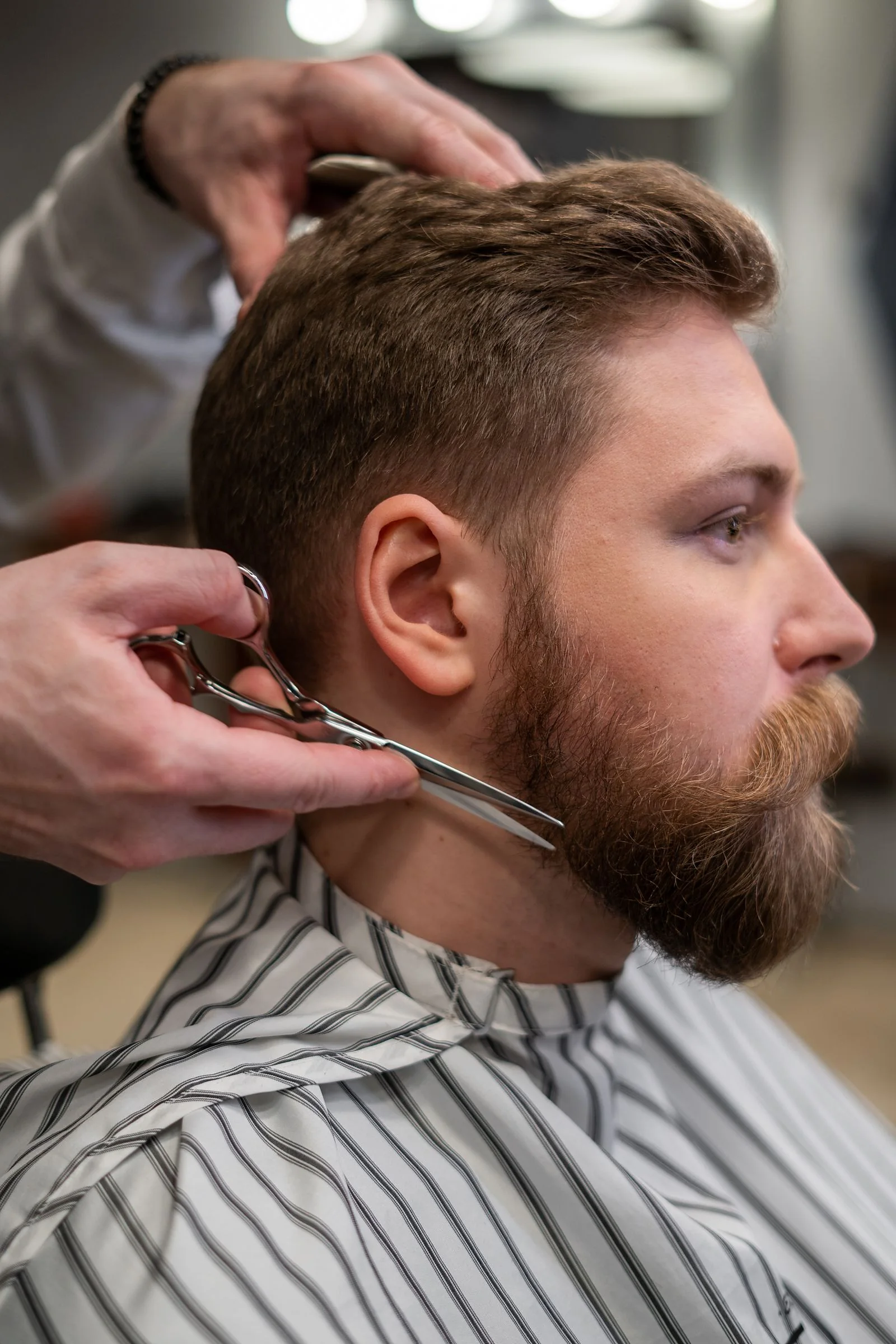 Barber schneidet einen Bart mit der Schere